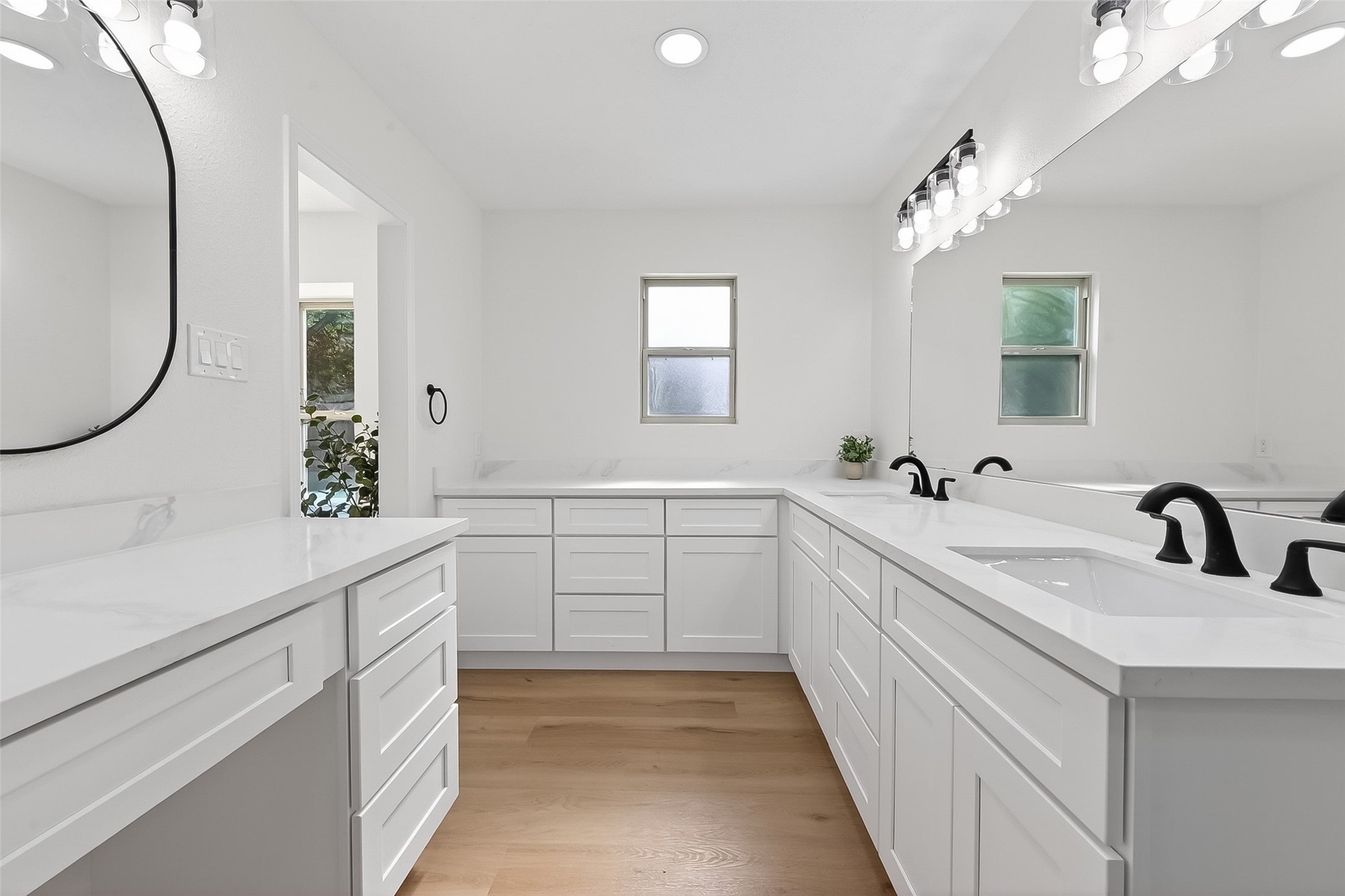 2914 Riata Lane Houston, TX 77043 - Photo 27 of 46 a spacious bathroom with a double vanity sink and a mirror