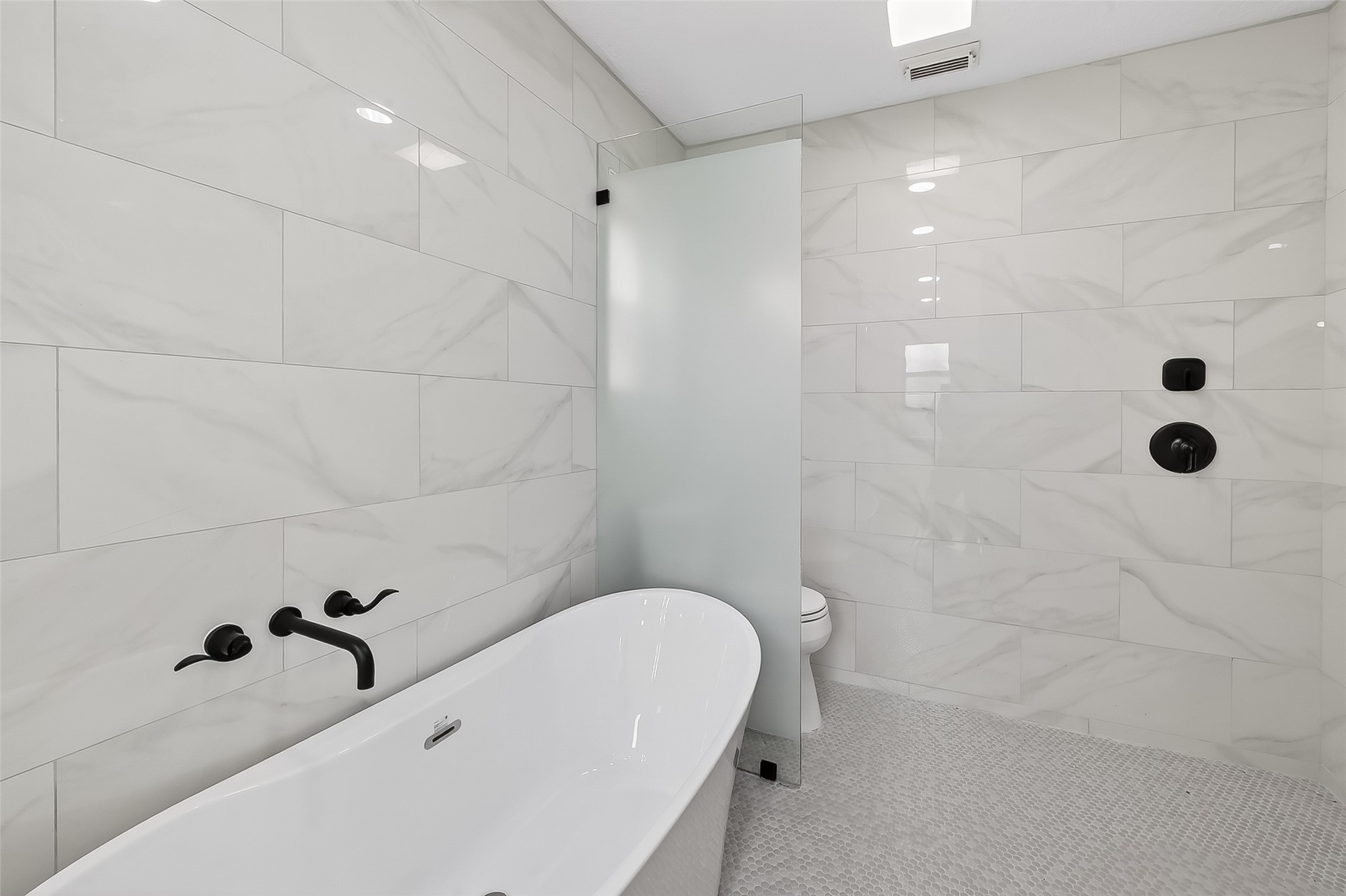 2914 Riata Lane Houston, TX 77043 - Photo 30 of 46 a bathroom with a tub and a shower