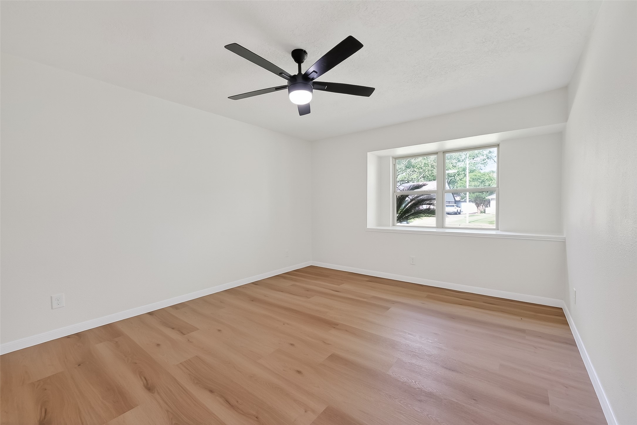 2914 Riata Lane Houston, TX 77043 - Photo 33 of 46 an empty room with wooden floor and windows
