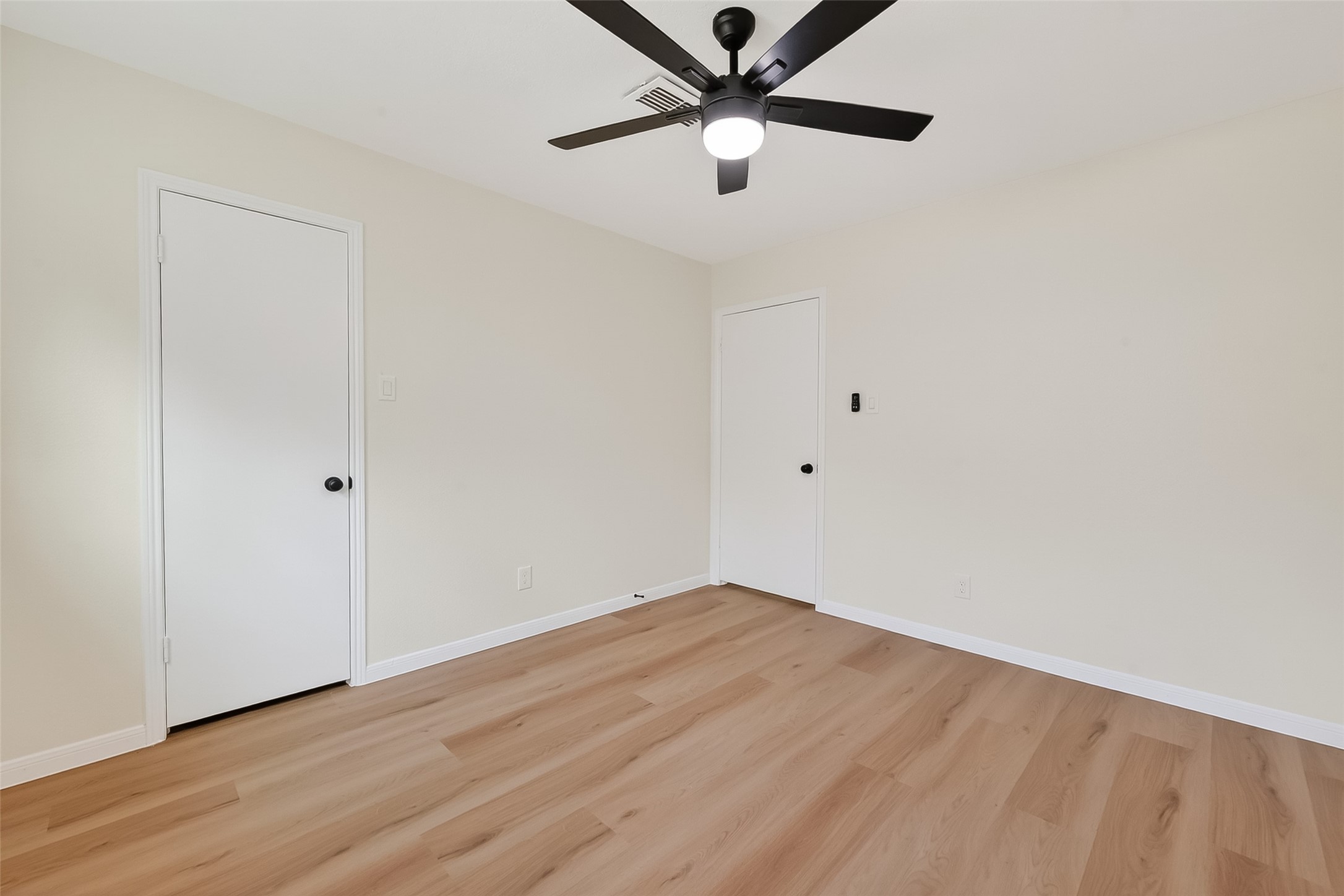 2914 Riata Lane Houston, TX 77043 - Photo 35 of 46 an empty room with wooden floor and windows