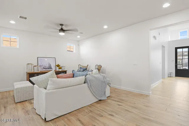 a living room with furniture and a ceiling fan