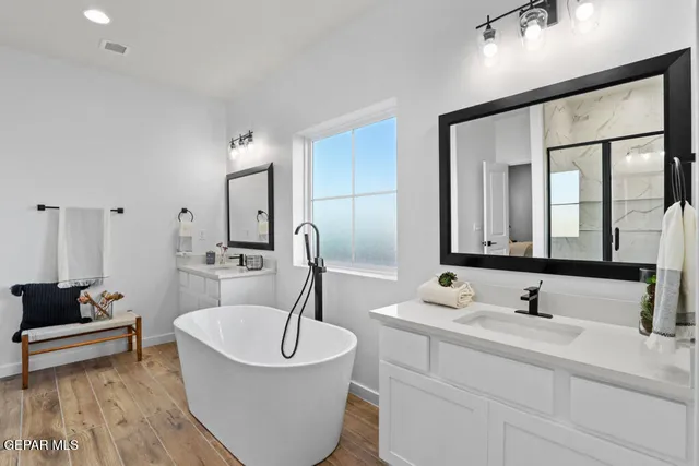 a bathroom with a sink and a large mirror