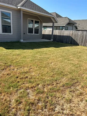 a view of a house with swimming pool next to a yard