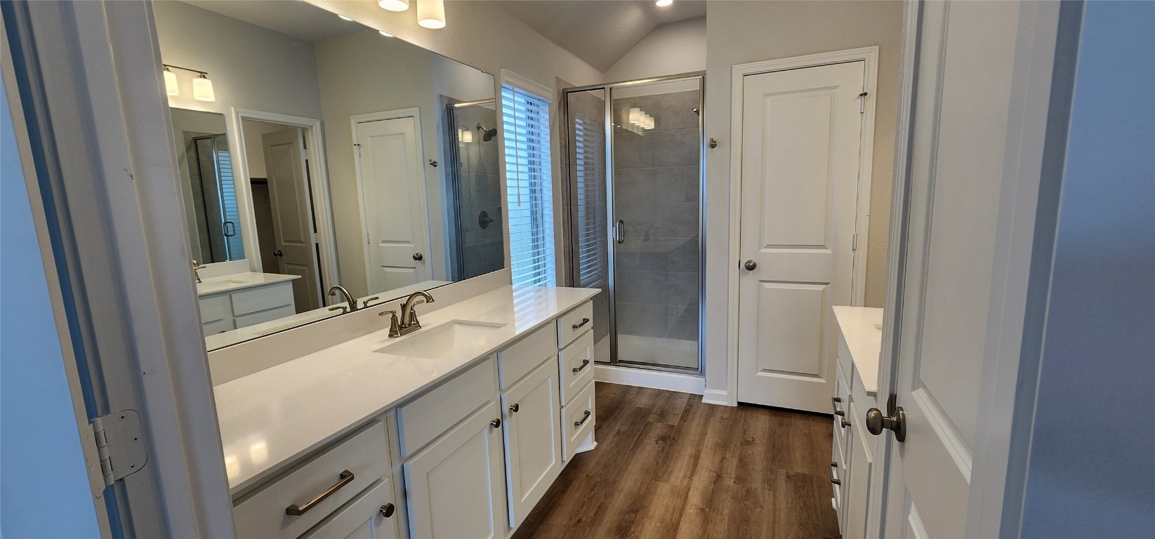 652 Los Olives Lane Georgetown, TX 78628 - Photo 22 of 36 a bathroom with a double vanity sink a mirror and a shower