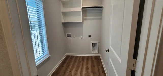 a view of a room with wooden floor and window