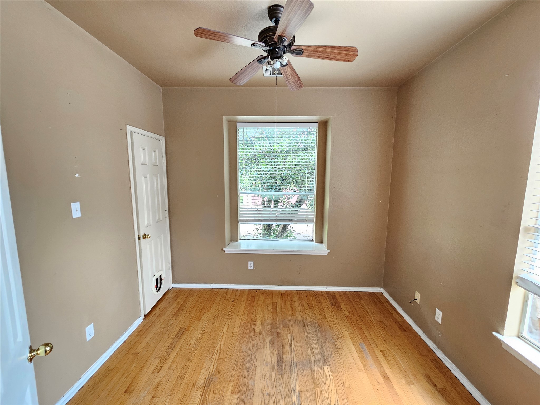 4672 Mather Kyle, TX 78640 - Photo 12 of 28 a view of empty room with a window and wooden floor