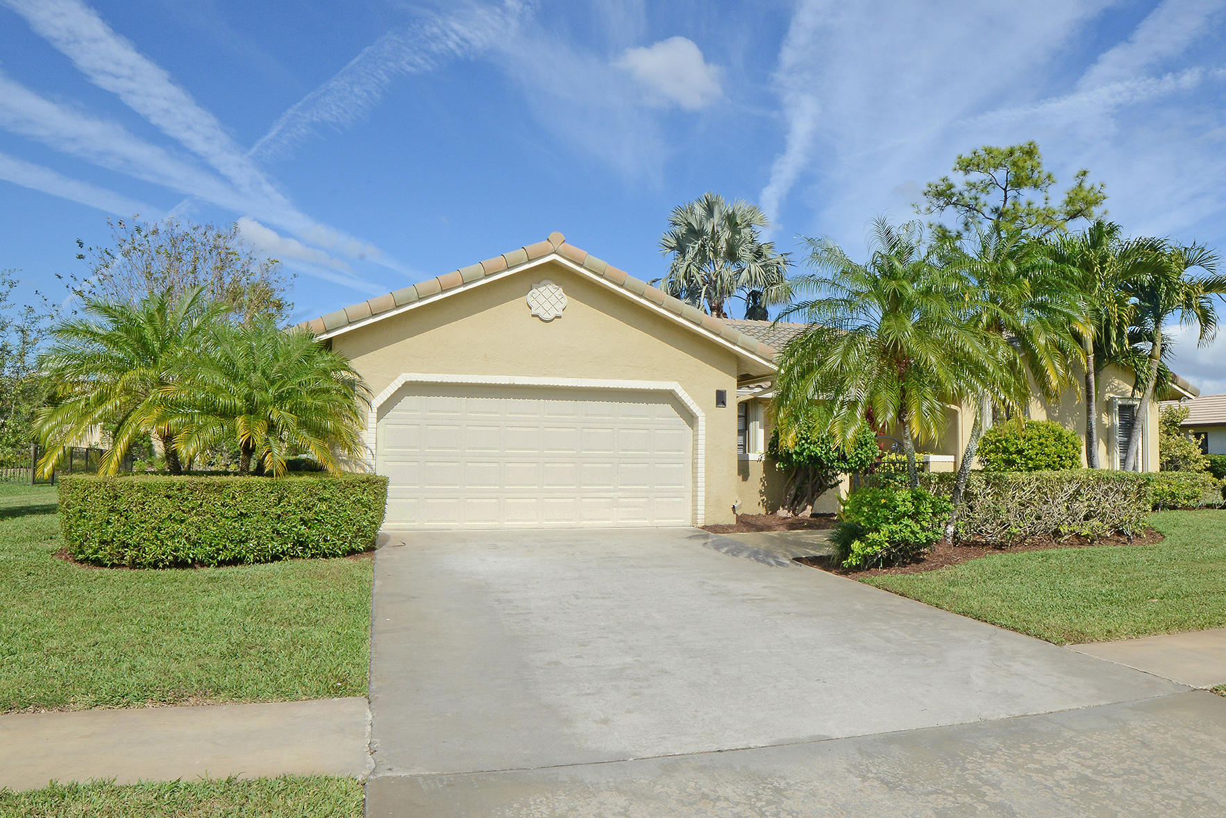 9053 Old Pine Road Boca Raton, FL 33428 - Photo 1 of 42 a front view of a house with a yard and garage