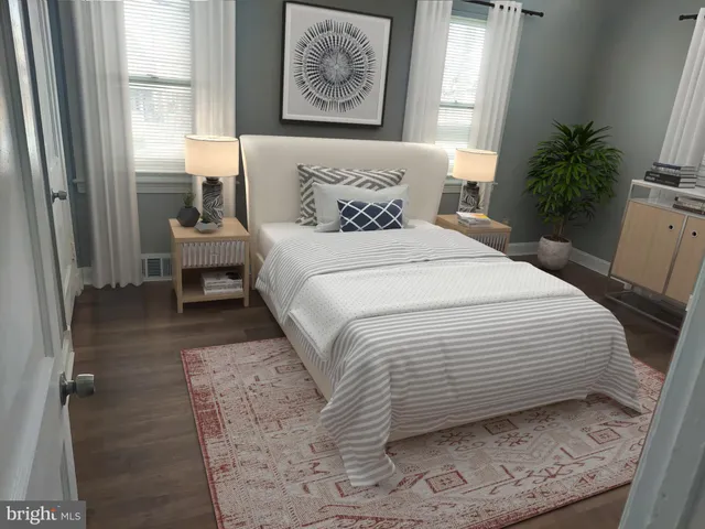 a bedroom with a bed and a painting on the wall