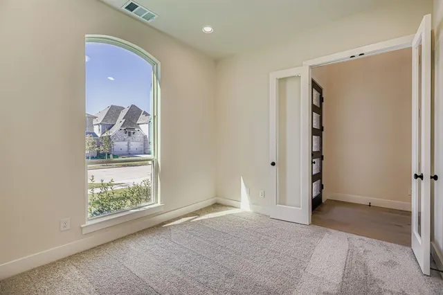 an empty room with windows and closet