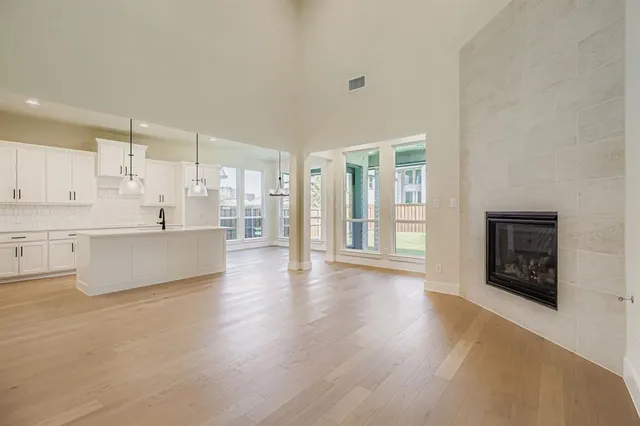 a large white kitchen with a large window
