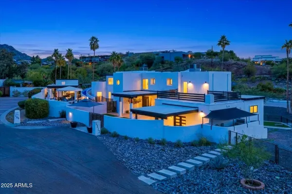 a view of a hallway with wooden staircase