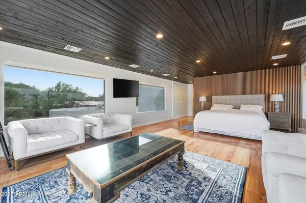 a view of a room with a ceiling fan and wooden floor