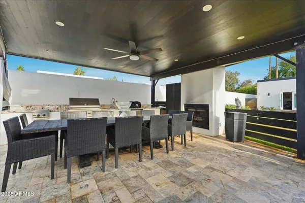 a view of a house with backyard and sitting area