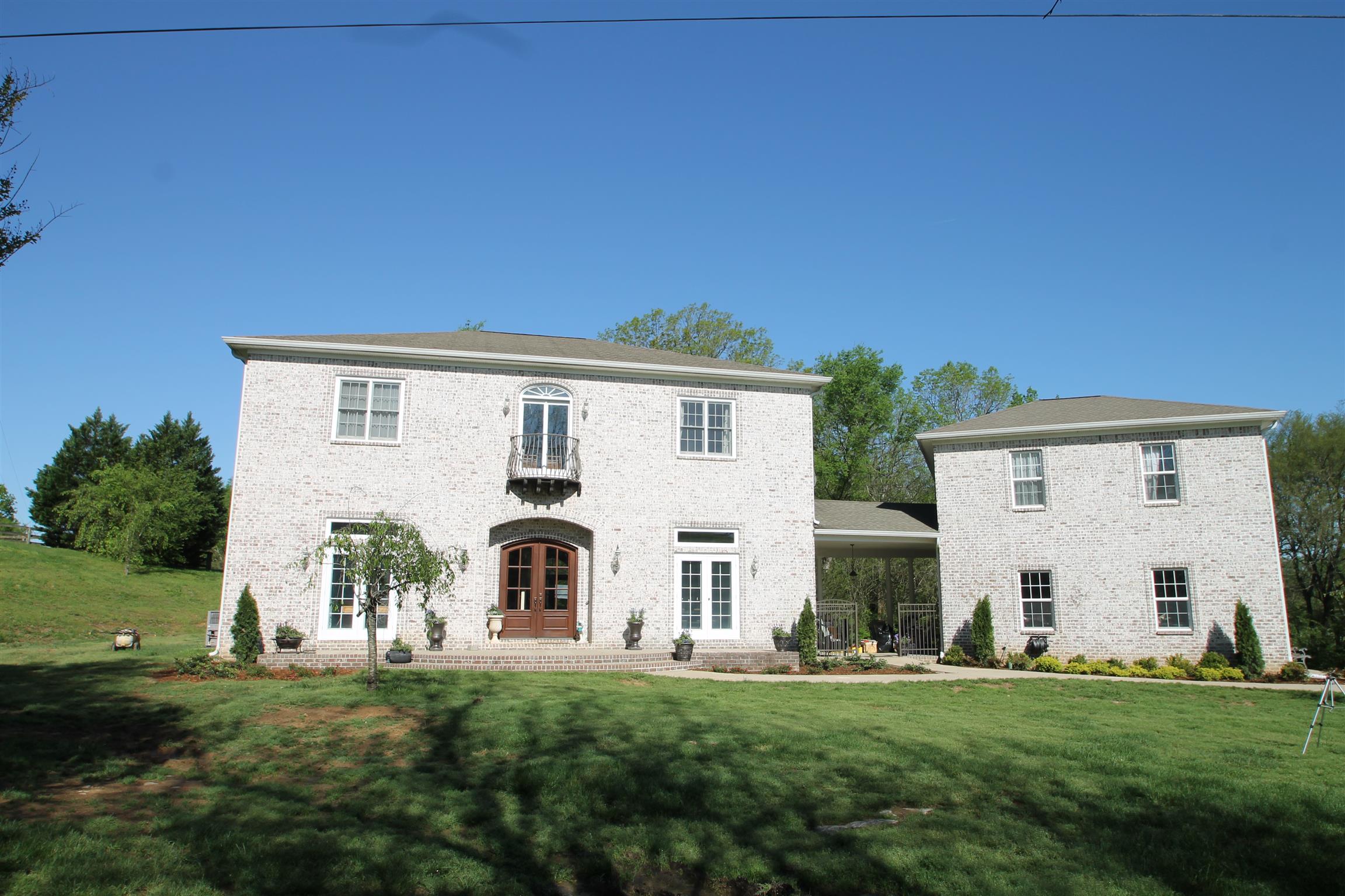 Impressive white washed brick with wrought iron balconies enhances the European flair