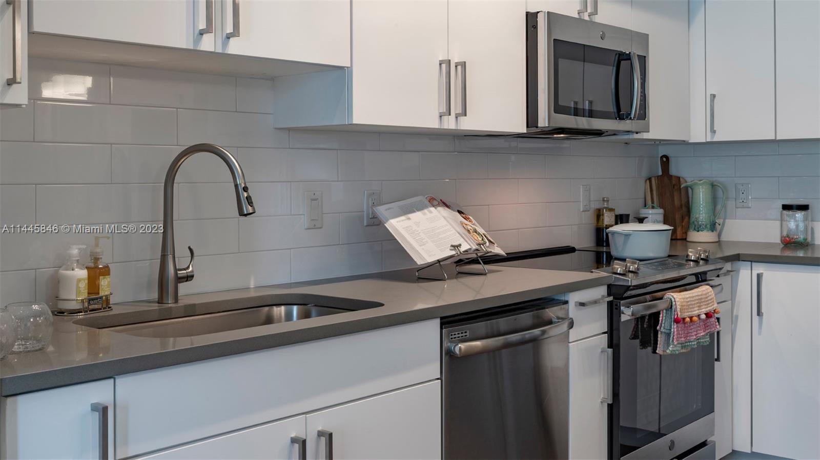 2701 Biscayne Boulevard, Unit 4111 Miami, FL 33137 - Photo 11 of 45 a kitchen with a sink and cabinets