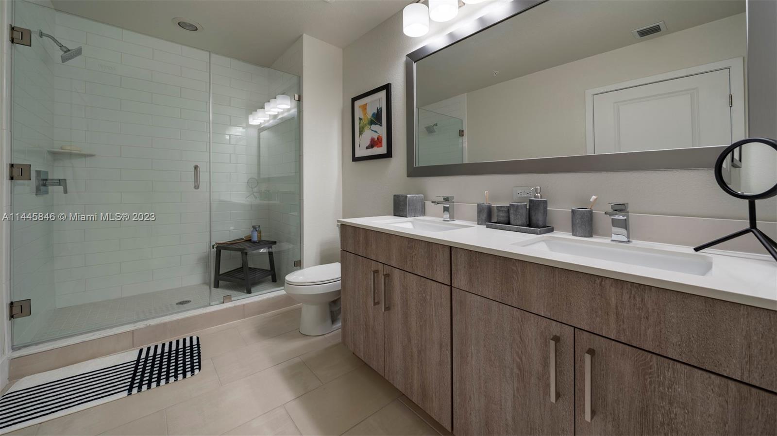 2701 Biscayne Boulevard, Unit 4111 Miami, FL 33137 - Photo 15 of 45 a bathroom with a sink a toilet and shower