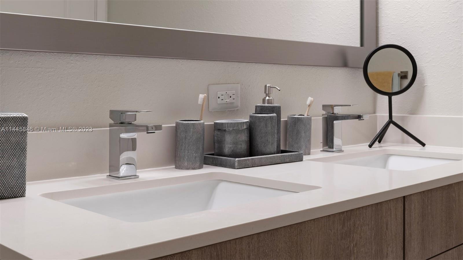 2701 Biscayne Boulevard, Unit 4111 Miami, FL 33137 - Photo 17 of 45 a bathroom with a sink and a mirror