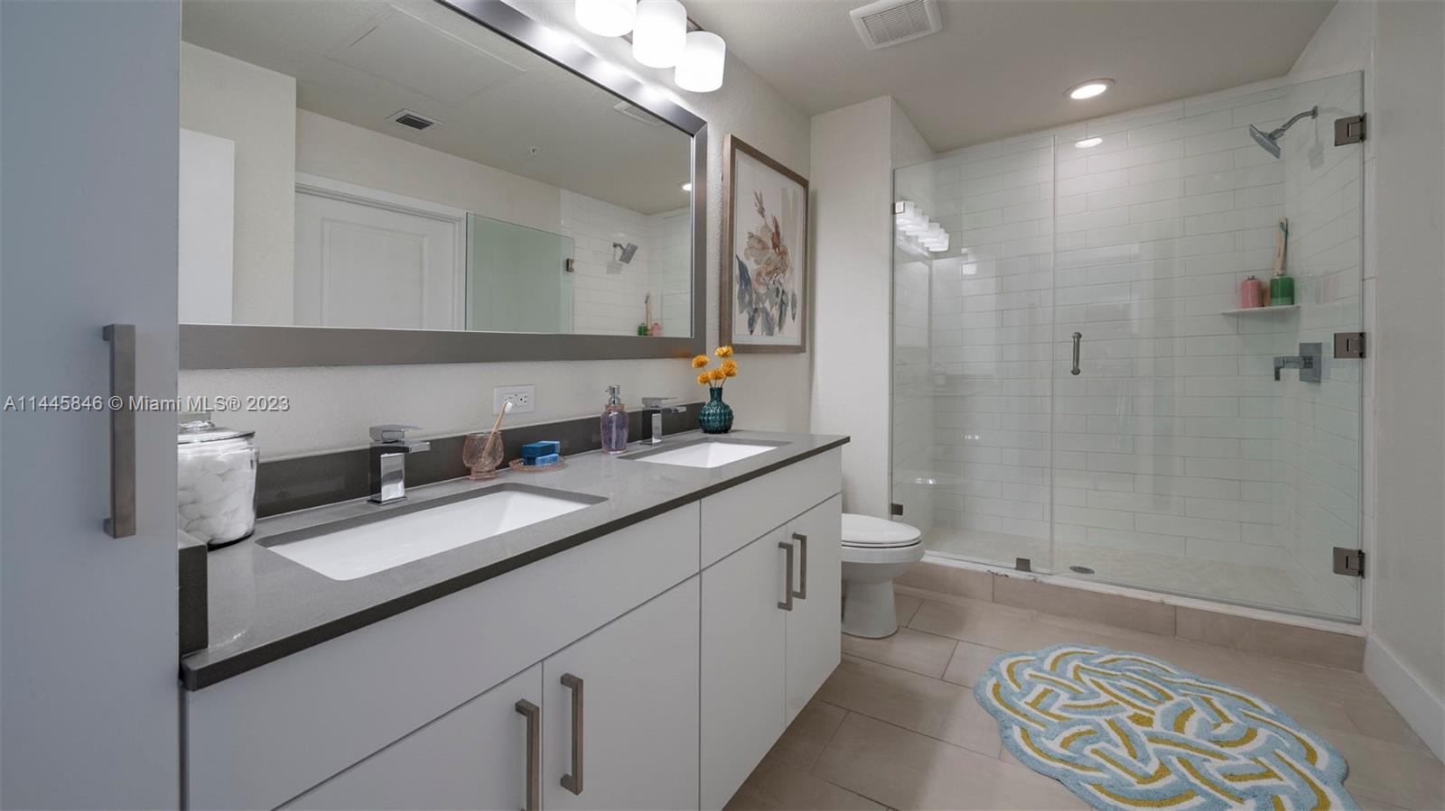 2701 Biscayne Boulevard, Unit 4111 Miami, FL 33137 - Photo 19 of 45 a bathroom with a double vanity sink toilet and shower
