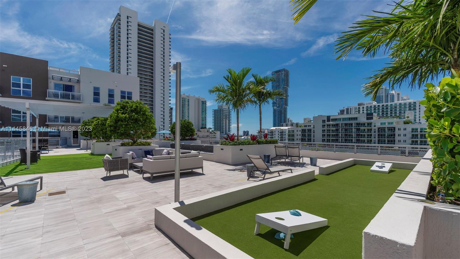 2701 Biscayne Boulevard, Unit 4111 Miami, FL 33137 - Photo 27 of 45 a view of a swimming pool with a lounge chairs