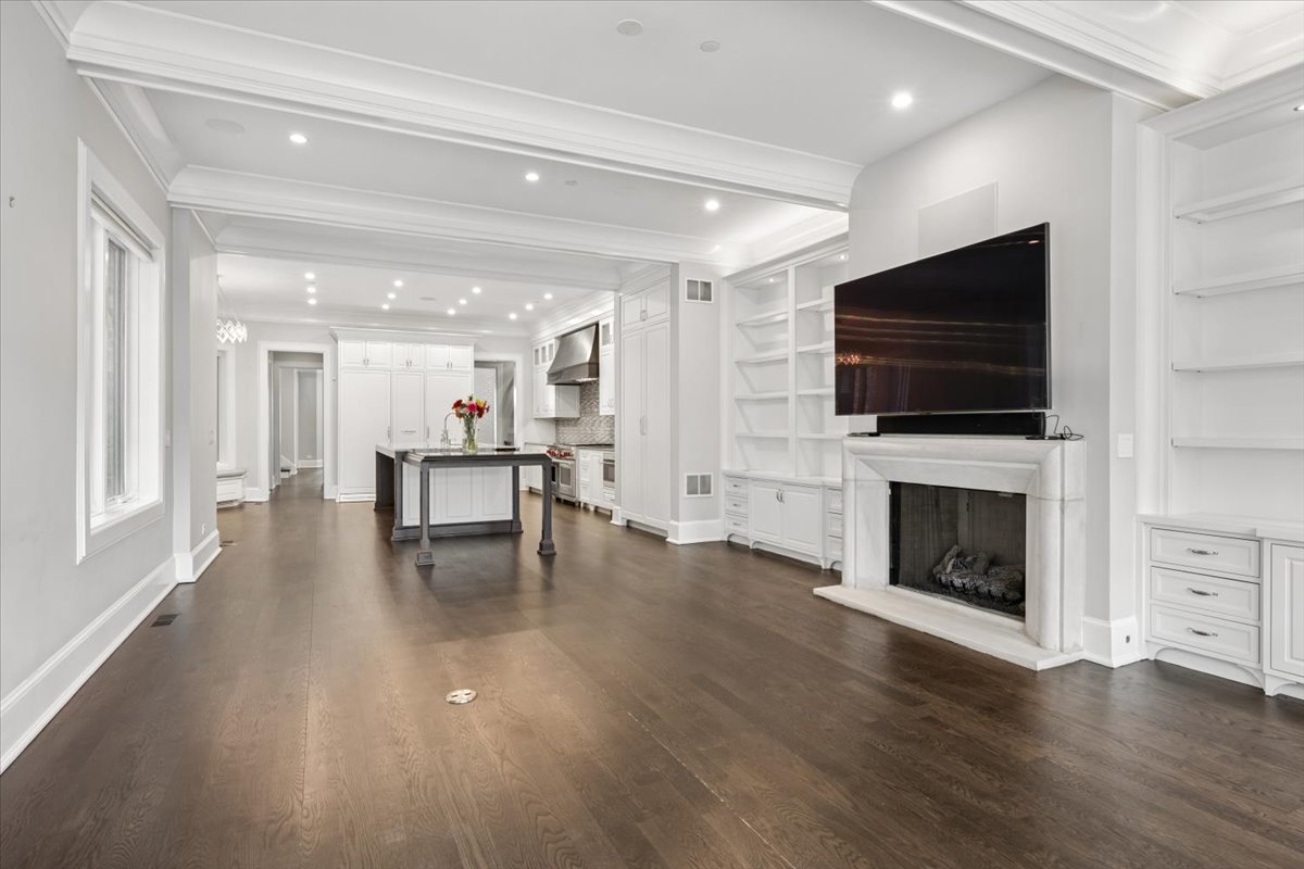458 West Deming Place Chicago, IL 60614 - Photo 13 of 39 a view of a livingroom with a fireplace a flat screen tv and staircase