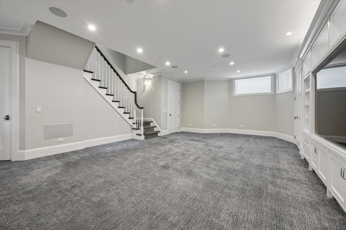 458 West Deming Place Chicago, IL 60614 - Photo 28 of 39 a view of an empty room with wooden floor and stairs