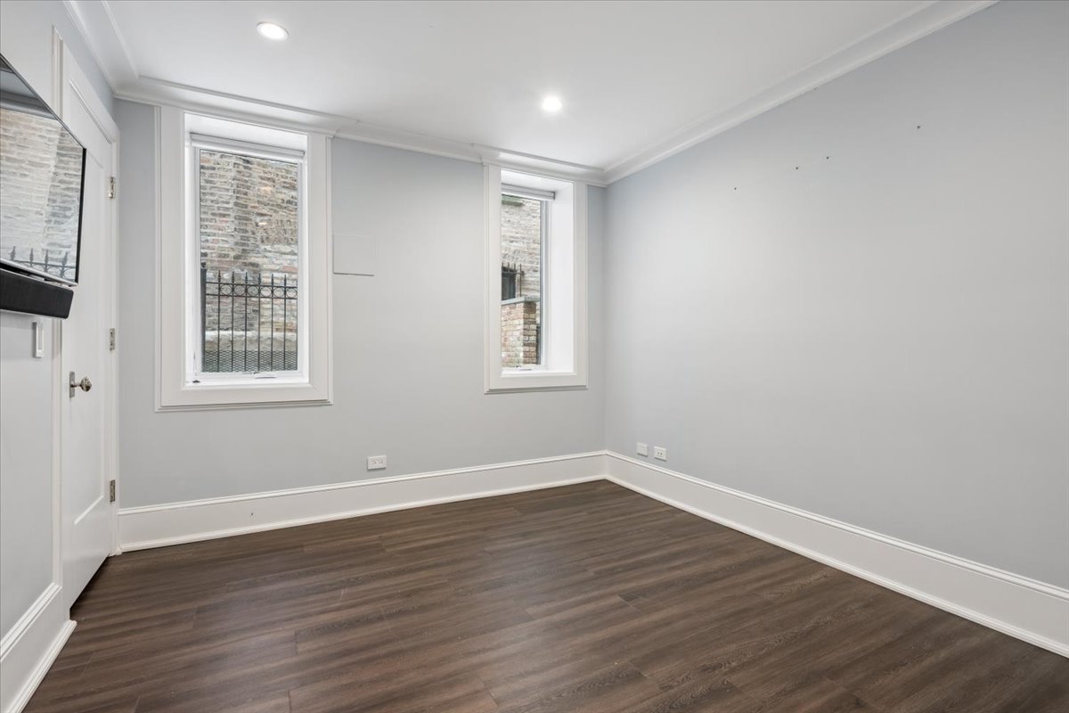 458 West Deming Place Chicago, IL 60614 - Photo 30 of 39 a view of an empty room with wooden floor and a window