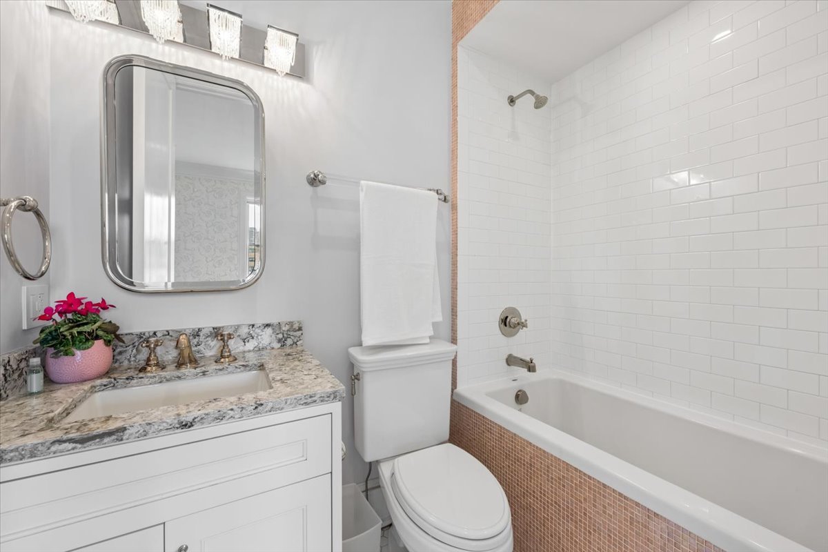 458 West Deming Place Chicago, IL 60614 - Photo 34 of 39 a bathroom with a granite countertop sink a toilet and a mirror