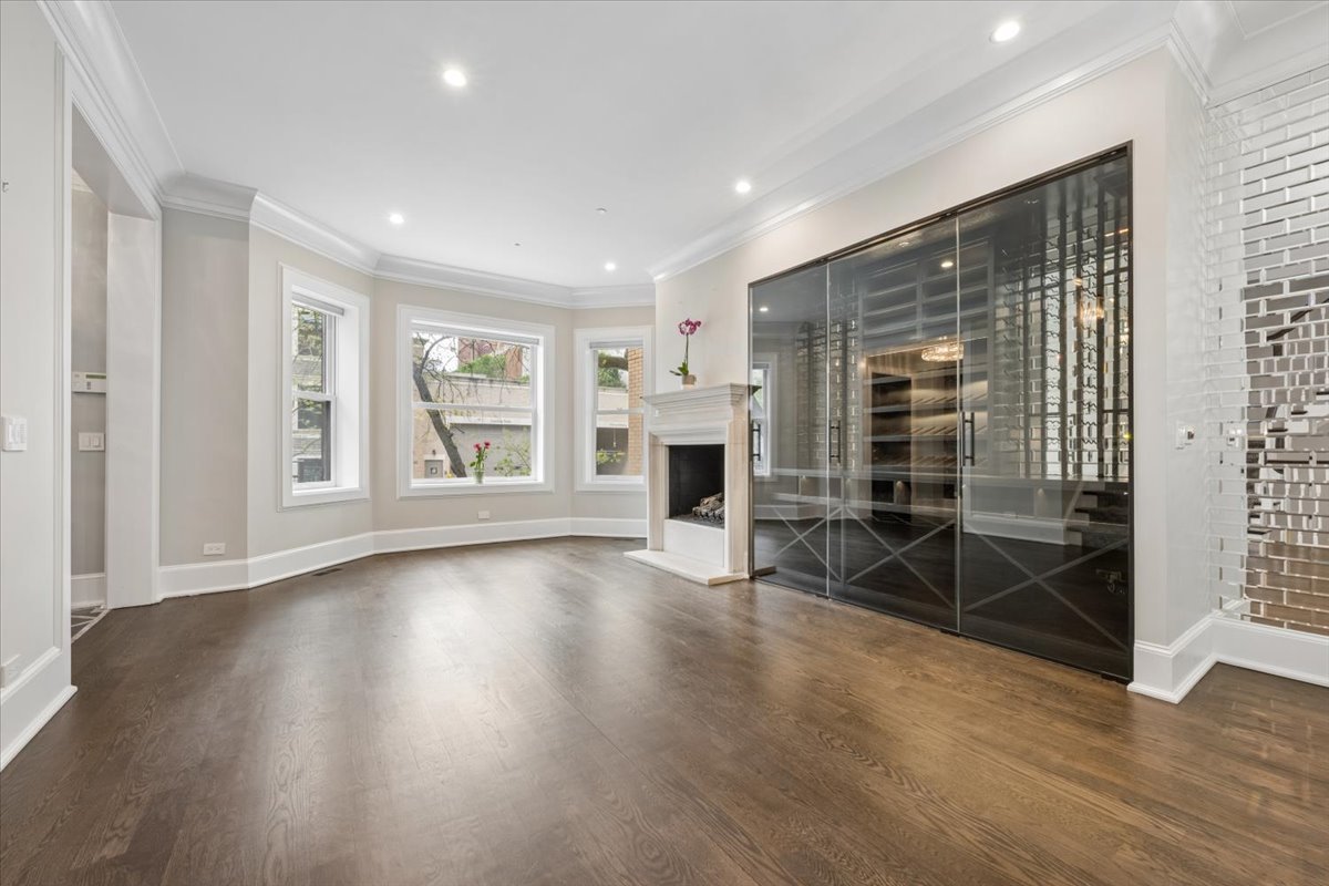 458 West Deming Place Chicago, IL 60614 - Photo 5 of 39 an empty room with wooden floor and fireplace