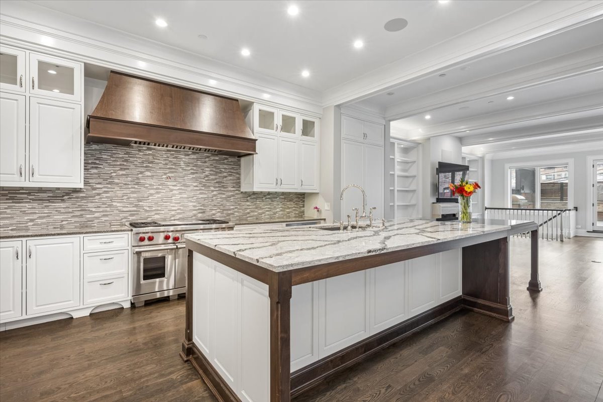 458 West Deming Place Chicago, IL 60614 - Photo 7 of 39 a kitchen with stainless steel appliances granite countertop a stove and a sink