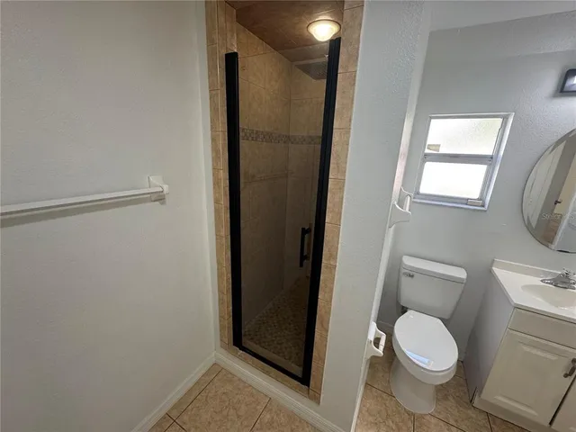 a white toilet sitting next to a bathroom sink