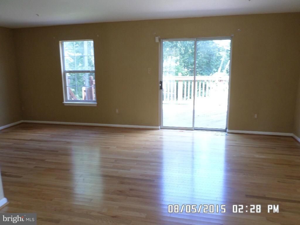 3520 Corn Stream Road Randallstown, MD 21133 - Photo 4 of 16 a view of an empty room with wooden floor and a window