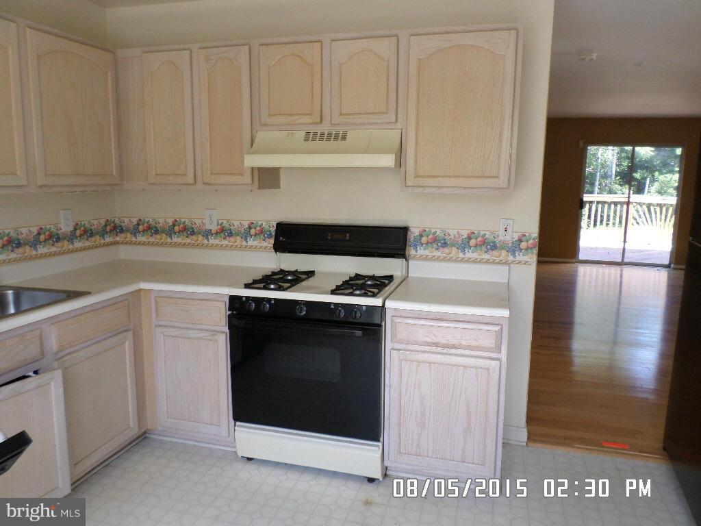3520 Corn Stream Road Randallstown, MD 21133 - Photo 5 of 16 a kitchen with white cabinets and appliances