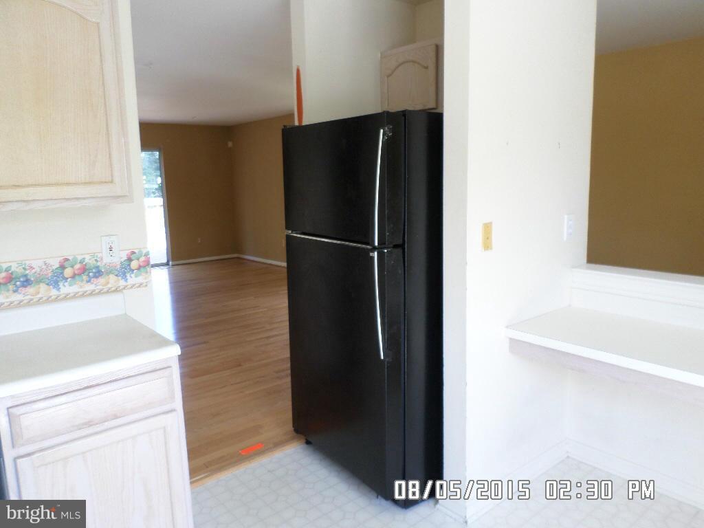 3520 Corn Stream Road Randallstown, MD 21133 - Photo 6 of 16 a view of a kitchen with a refrigerator and a sink
