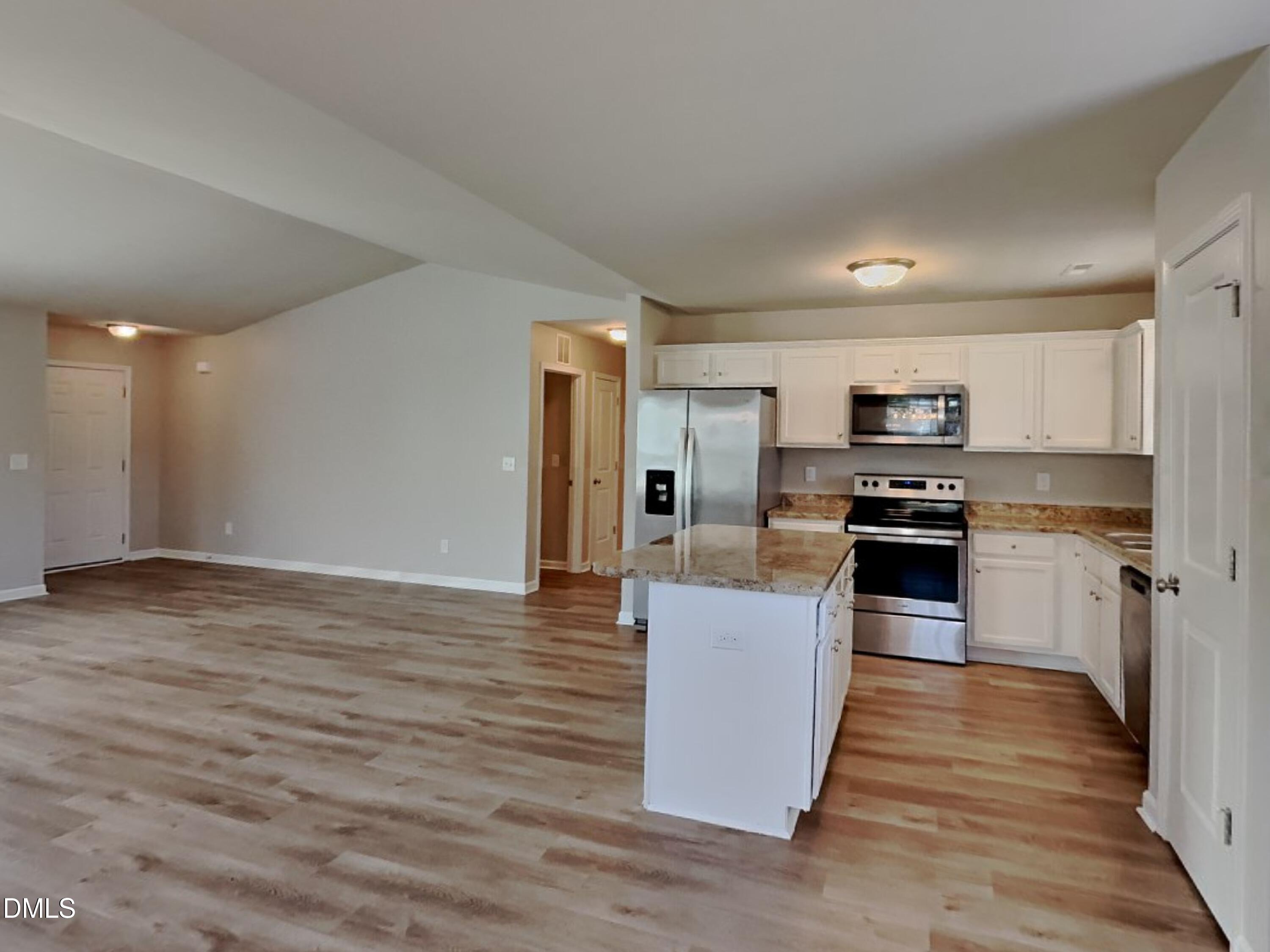 123 Willow Ridge Circle Willow Spring, NC 27592 - Photo 5 of 15 a kitchen with stainless steel appliances granite countertop a stove top oven a sink dishwasher and a refrigerator