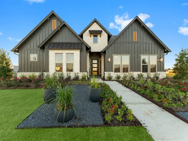 a front view of house with a garden