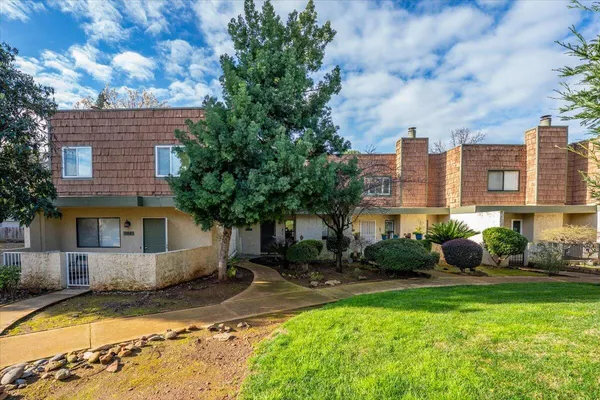 a front view of a house with garden