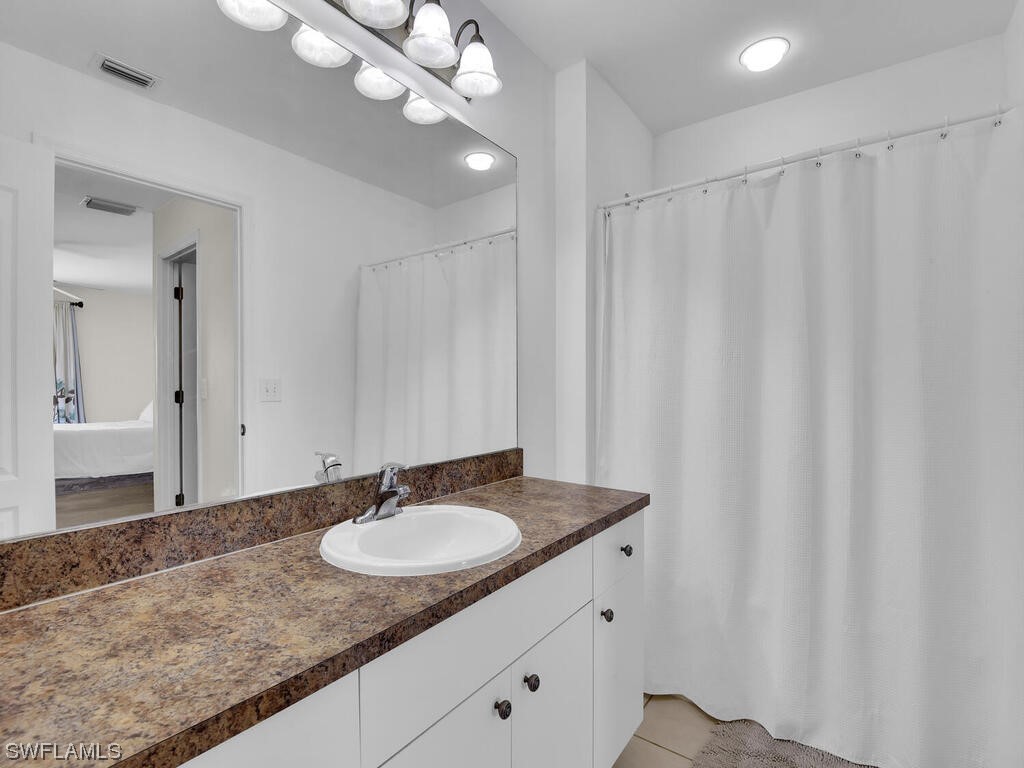 3960 Sunset Road Lehigh Acres, FL 33971 - Photo 14 of 23 a sink and a mirror