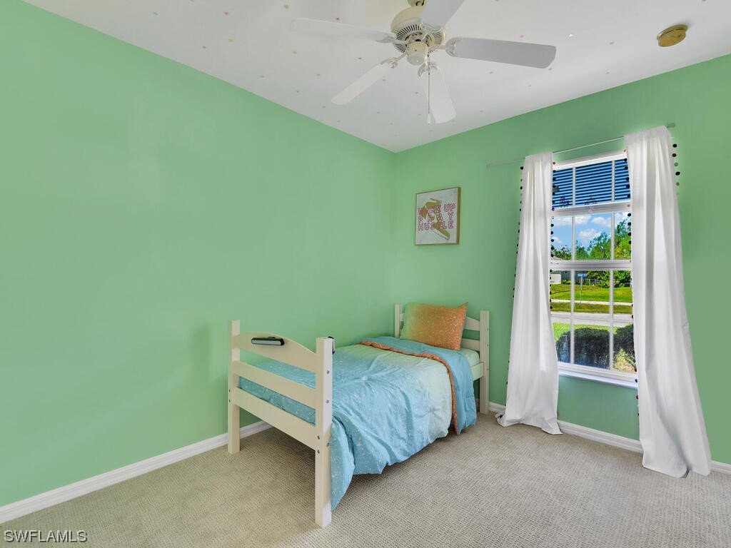 3960 Sunset Road Lehigh Acres, FL 33971 - Photo 15 of 23 a bedroom with a bed and a window