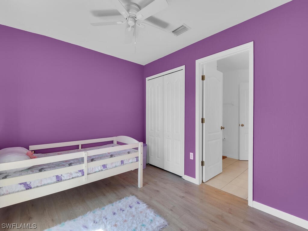 3960 Sunset Road Lehigh Acres, FL 33971 - Photo 19 of 23 a room with a dresser and chandelier