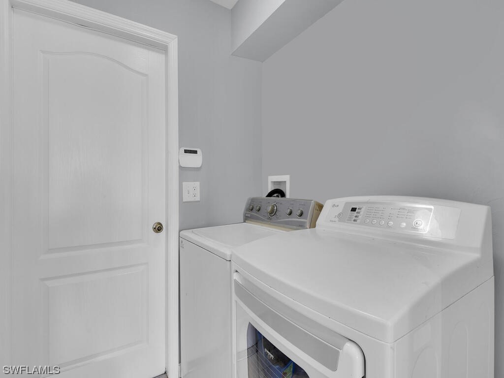 3960 Sunset Road Lehigh Acres, FL 33971 - Photo 20 of 23 a utility room with dryer and washer