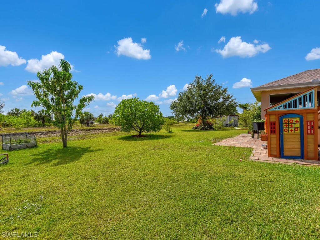 3960 Sunset Road Lehigh Acres, FL 33971 - Photo 22 of 23 a view of a house with a backyard