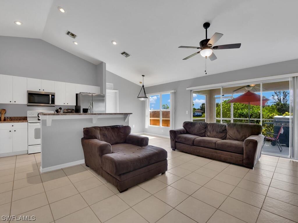 3960 Sunset Road Lehigh Acres, FL 33971 - Photo 3 of 23 a living room with furniture and a flat screen tv