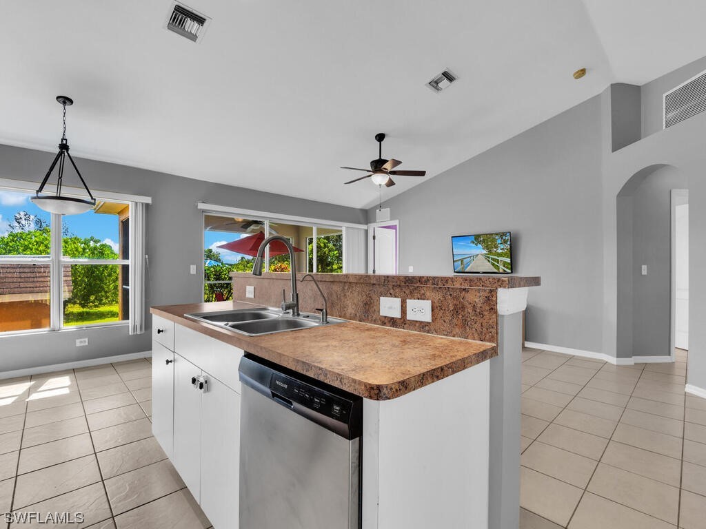 3960 Sunset Road Lehigh Acres, FL 33971 - Photo 5 of 23 a kitchen with a sink a counter top space and appliances