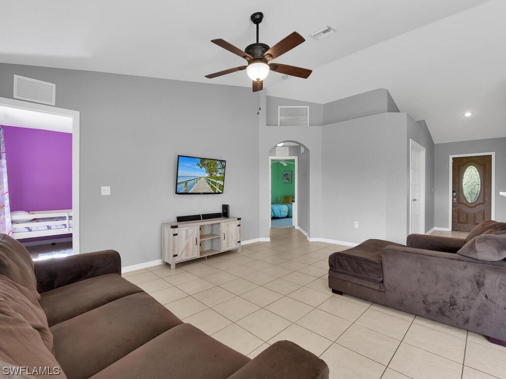 3960 Sunset Road Lehigh Acres, FL 33971 - Photo 9 of 23 a living room with furniture and a large window