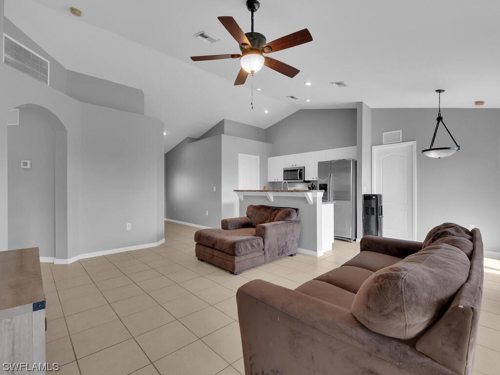 3960 Sunset Road Lehigh Acres, FL 33971 - Photo 10 of 23 a living room with furniture a ceiling fan and a rug