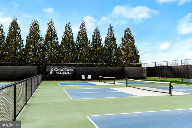 a view of a patio with lawn chairs couches and swimming pool