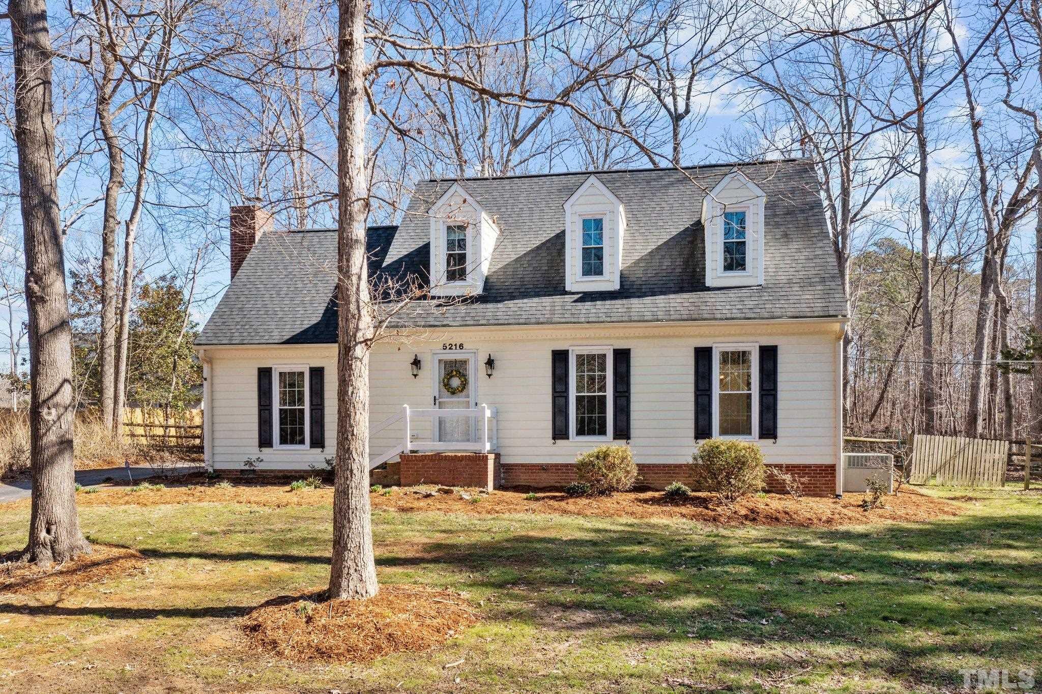 5216 Hallmark Road Durham, NC 27712 - Photo 1 of 24 a view of a white house with large windows and a small yard