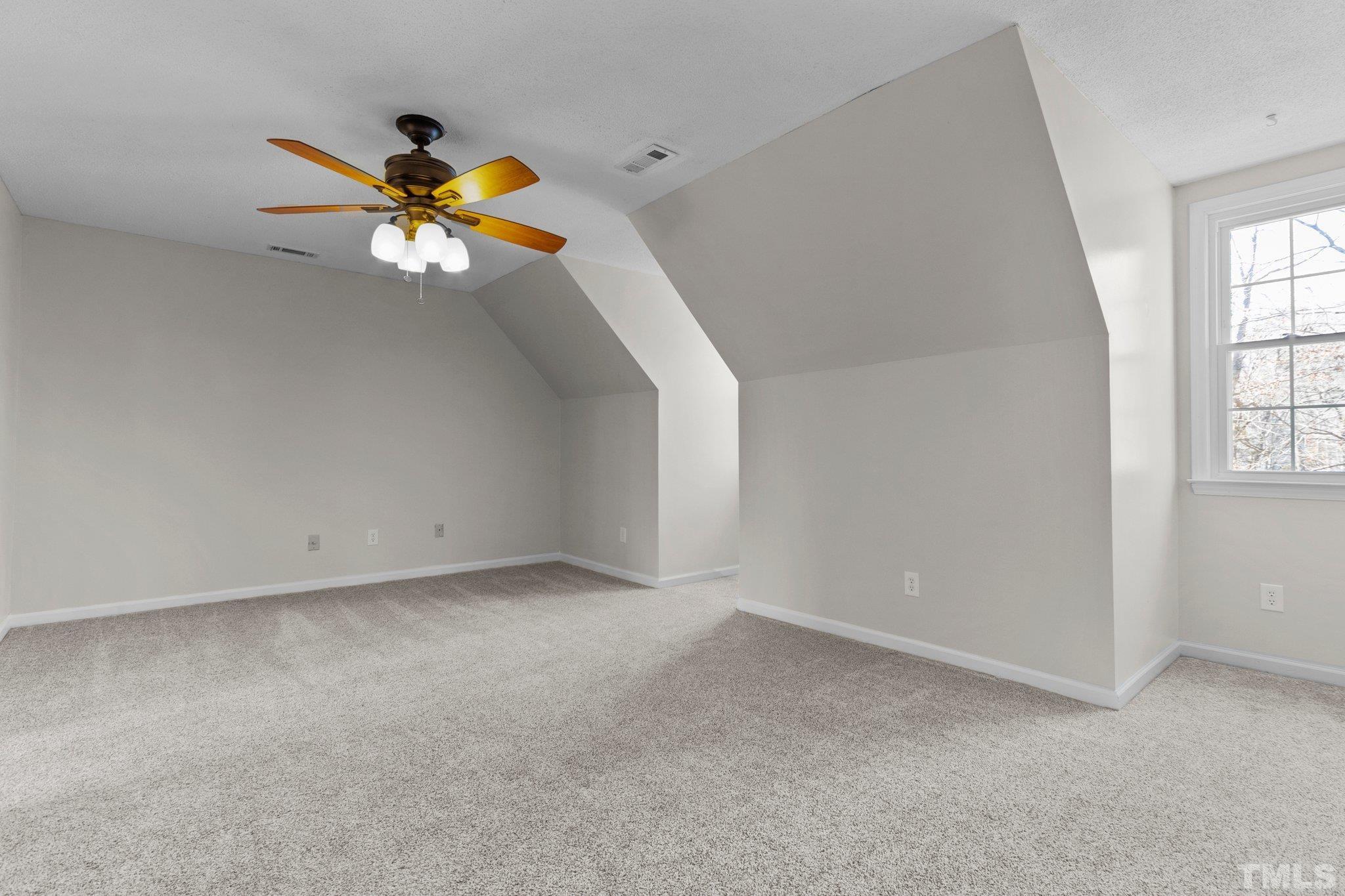 5216 Hallmark Road Durham, NC 27712 - Photo 14 of 24 an empty room with windows and chandelier fan
