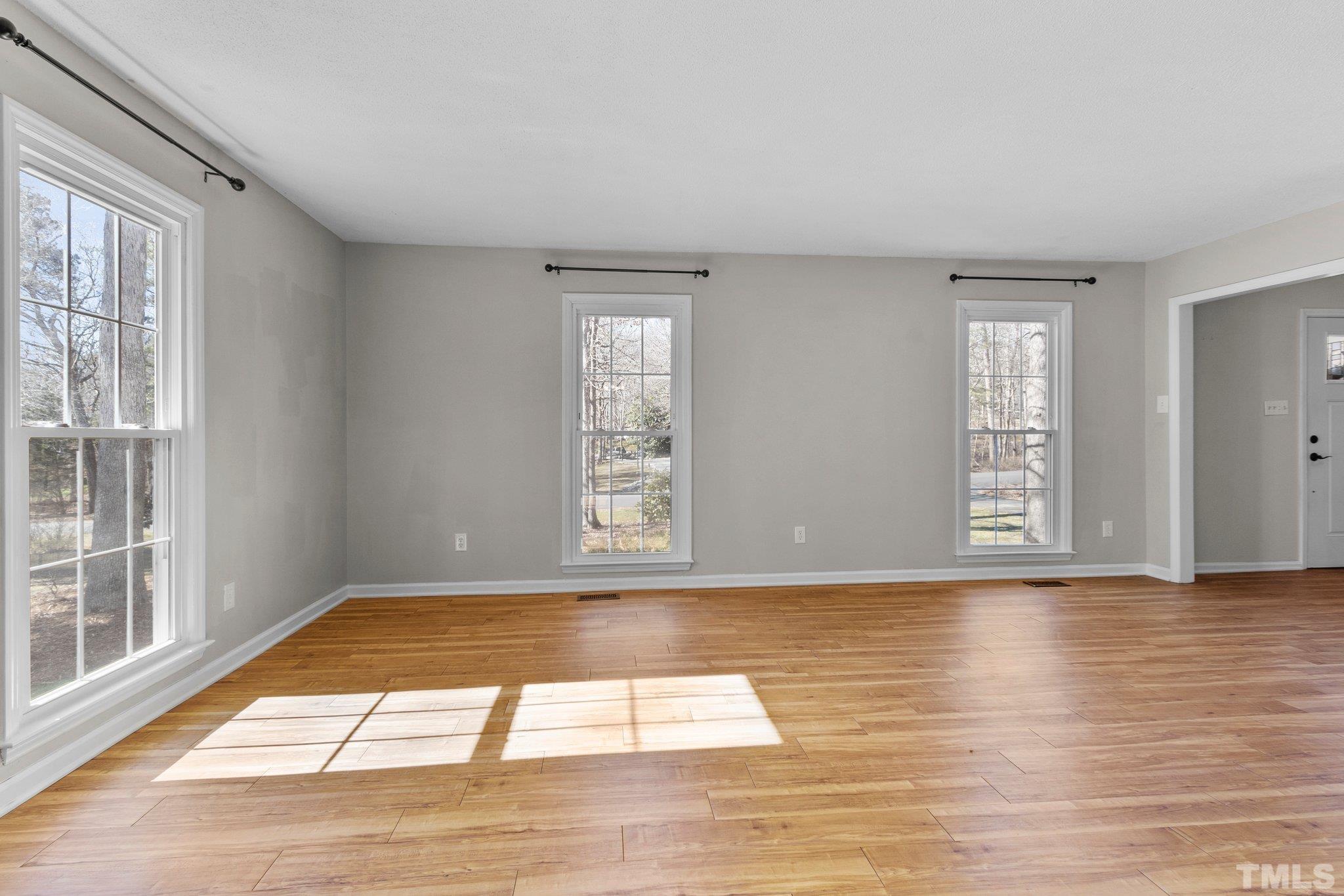 5216 Hallmark Road Durham, NC 27712 - Photo 3 of 24 a view of an empty room with wooden floor and a window