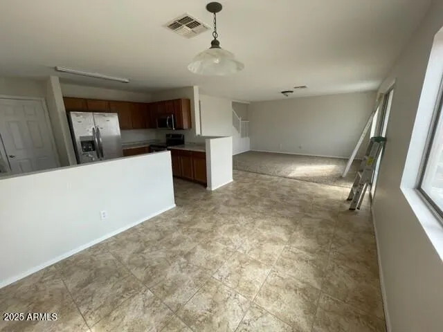 a view of a kitchen with a sink and cabinets
